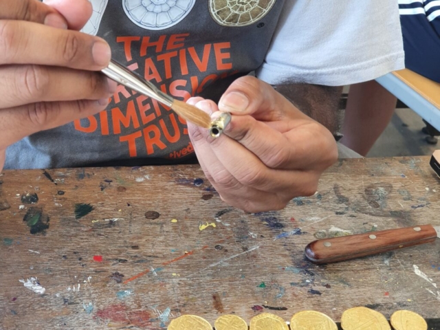 Young person learning gilding