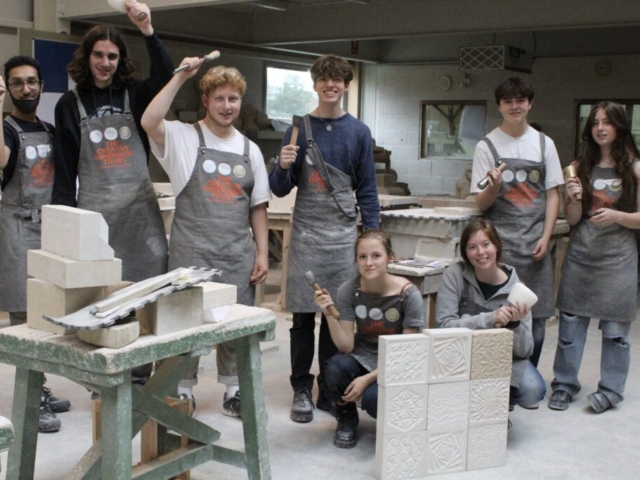 Young people at a stone carving workshop