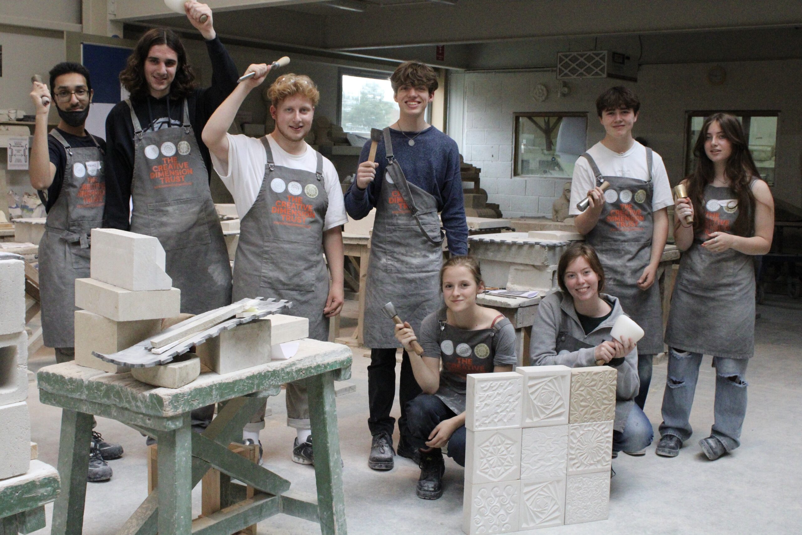 Young people at a stone carving workshop